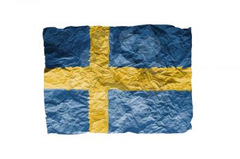 Close up of a curled paper on white background, print of the flag of Sweden
