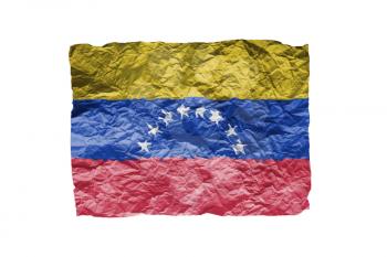 Close up of a curled paper on white background, print of the flag of Venezuela
