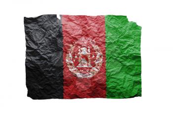 Close up of a curled paper on white background, print of the flag of Afghanistan
