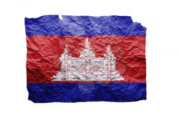 Close up of a curled paper on white background, print of the flag of Cambodia