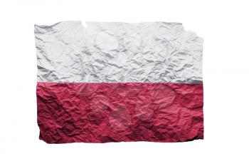 Close up of a curled paper on white background, print of the flag of Poland