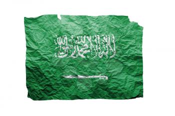 Close up of a curled paper on white background, print of the flag of Saudi Arabia