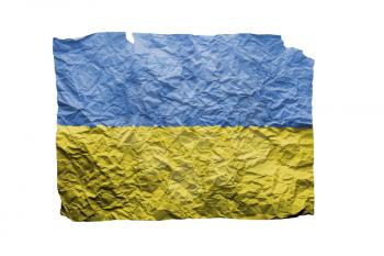 Close up of a curled paper on white background, print of the flag of Ukraine