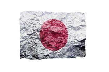 Close up of a curled paper on white background, print of the flag of Japan