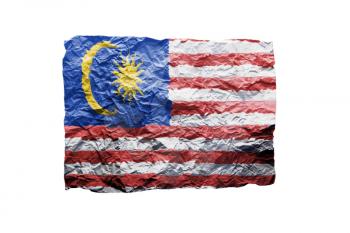 Close up of a curled paper on white background, print of the flag of Malaysia