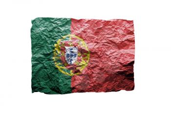 Close up of a curled paper on white background, print of the flag of Portugal