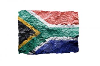 Close up of a curled paper on white background, print of the flag of South Africa