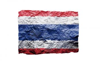 Close up of a curled paper on white background, print of the flag of Thailand