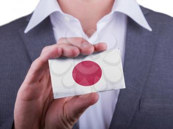 Businessman showing card, matte paper effect, Japan