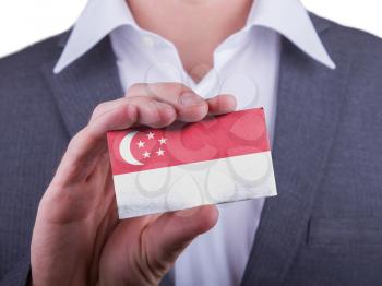 Businessman showing card, matte paper effect, Singapore