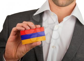Businessman is holding a business card, flag of Armenia