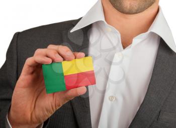 Businessman is holding a business card, flag of Benin