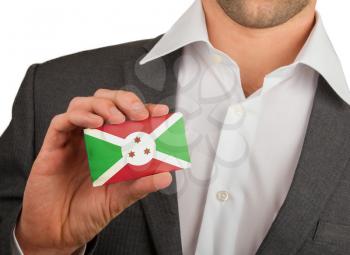 Businessman is holding a business card, flag of Burundi