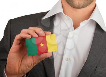 Businessman is holding a business card, flag of Cameroon