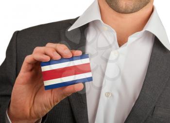 Businessman is holding a business card, flag of Costa Rica