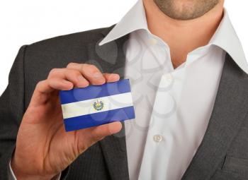 Businessman is holding a business card, flag of El Salvador