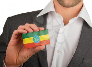 Businessman is holding a business card, flag of Ethiopia