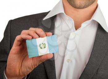 Businessman is holding a business card, flag of Guatamala