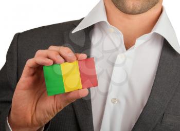 Businessman is holding a business card, flag of Mali