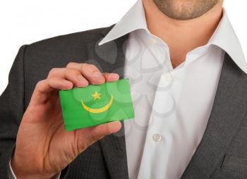 Businessman is holding a business card, flag of Mauritania