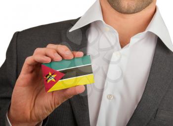 Businessman is holding a business card, flag of Mozambique