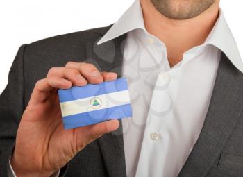 Businessman is holding a business card, flag of Nicaragua