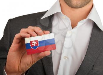 Businessman is holding a business card, flag of Slovakia