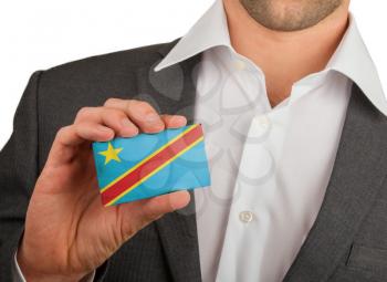 Businessman is holding a business card, flag of The Democratic Republic Of The Congo