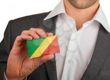 Businessman is holding a business card, flag of Republic of Congo