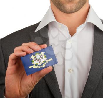 Businessman is holding a business card, flag of Connecticut
