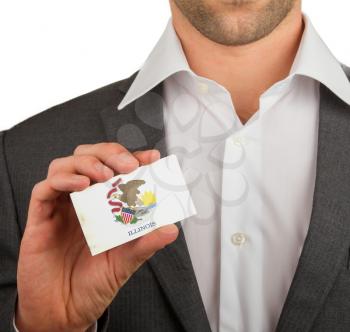 Businessman is holding a business card, flag of Illinois