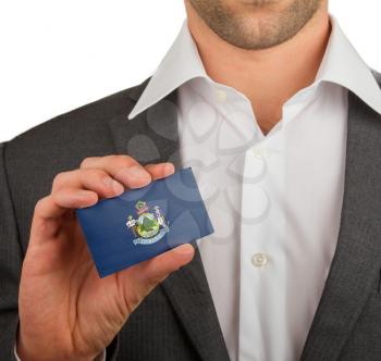Businessman is holding a business card, flag of Maine