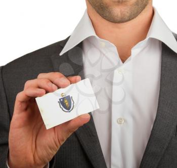 Businessman is holding a business card, flag of Massachusetts