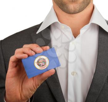 Businessman is holding a business card, flag of Minnesota