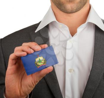 Businessman is holding a business card, flag of Vermont