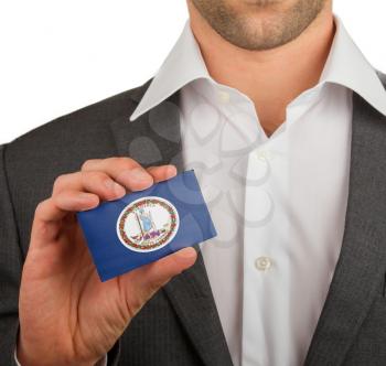 Businessman is holding a business card, flag of Virginia