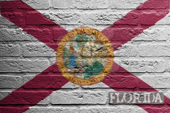 Brick wall with a painting of a flag isolated, Florida