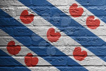 Brick wall with a painting of a flag isolated, Friesland