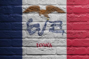 Brick wall with a painting of a flag isolated, Iowa