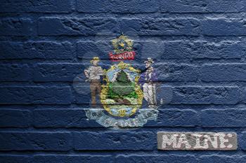 Brick wall with a painting of a flag isolated, Maine