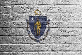 Brick wall with a painting of a flag isolated, Massachusetts