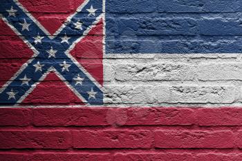 Brick wall with a painting of a flag isolated, Mississippi