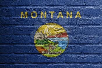 Brick wall with a painting of a flag isolated, Montana