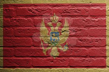 Brick wall with a painting of a flag isolated, Montenegro