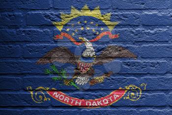 Brick wall with a painting of a flag isolated, North Dakota