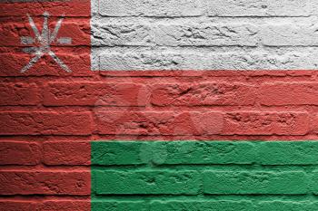 Brick wall with a painting of a flag isolated, Oman