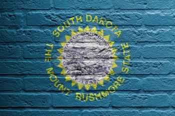 Brick wall with a painting of a flag isolated, South Dakota