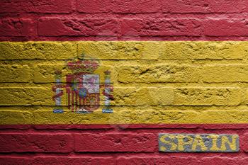 Brick wall with a painting of a flag isolated, Spain