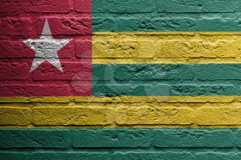 Brick wall with a painting of a flag isolated, Togo