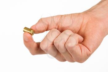 Hand holding an empty bullet shell, isolated on white